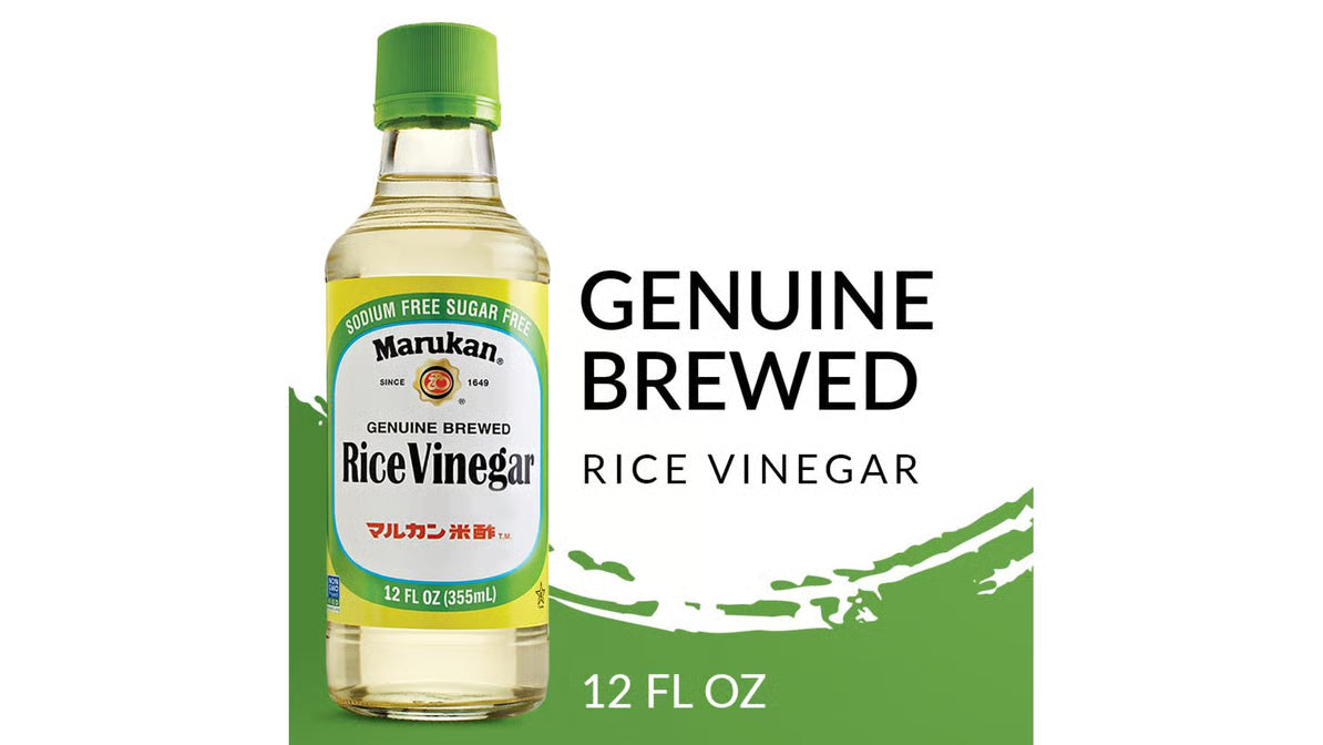 Bottle of Marukan rice vinegar with green cap on a white background