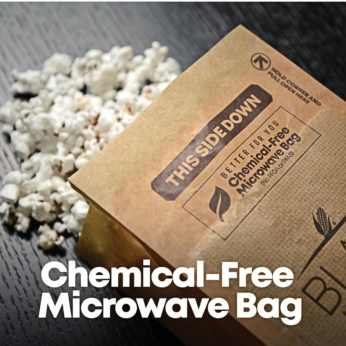 Kraft paper microwaveable popcorn bag with text on a wooden surface with popped popcorn.