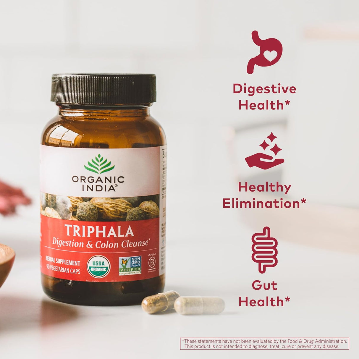 Bottle of Organic India Triphala supplement with health benefits on a white background