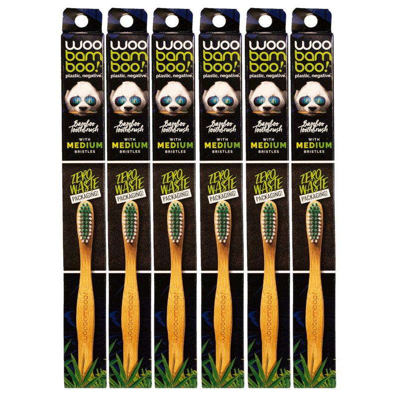 Packaging of bamboo toothbrushes with visible branding and product details.