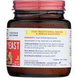 Jar of yeast with a red lid and label on a white background