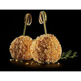 Two breaded food items on skewers with a black background