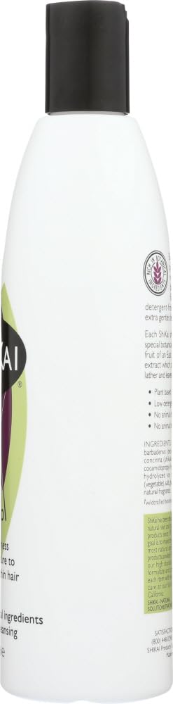 White bottle with black cap and green label on a white background