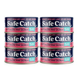 Four cans of Safe Catch pink salmon on a white background