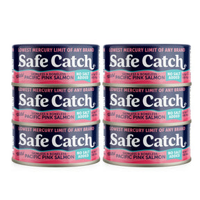 Four cans of Safe Catch pink salmon on a white background