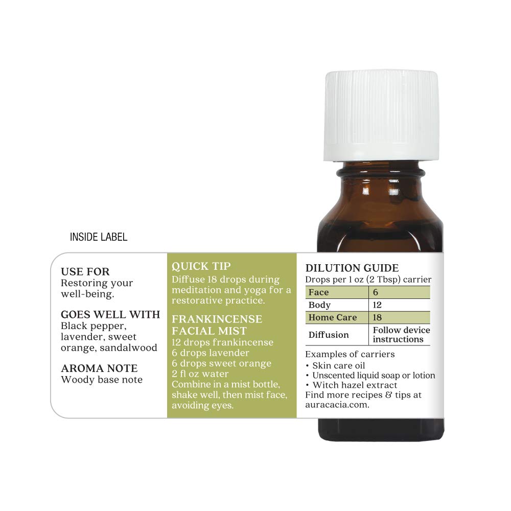 Bottle of essential oil with a label on a white background