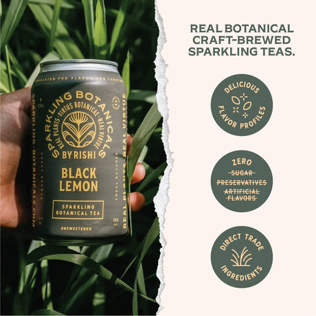 Hand holding a can of 'Black Lemon' sparkling botanical tea with brand details on a green leafy background.