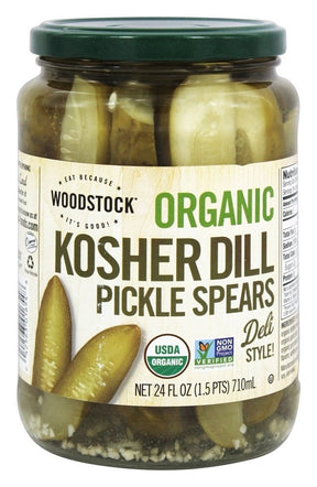 Jar of Woodstock Organic Kosher Dill Pickle Spears with a green lid on a white background