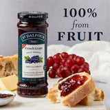 Jar of St. Dalfour French Grape Fruit Spread with grapes and bread on a table