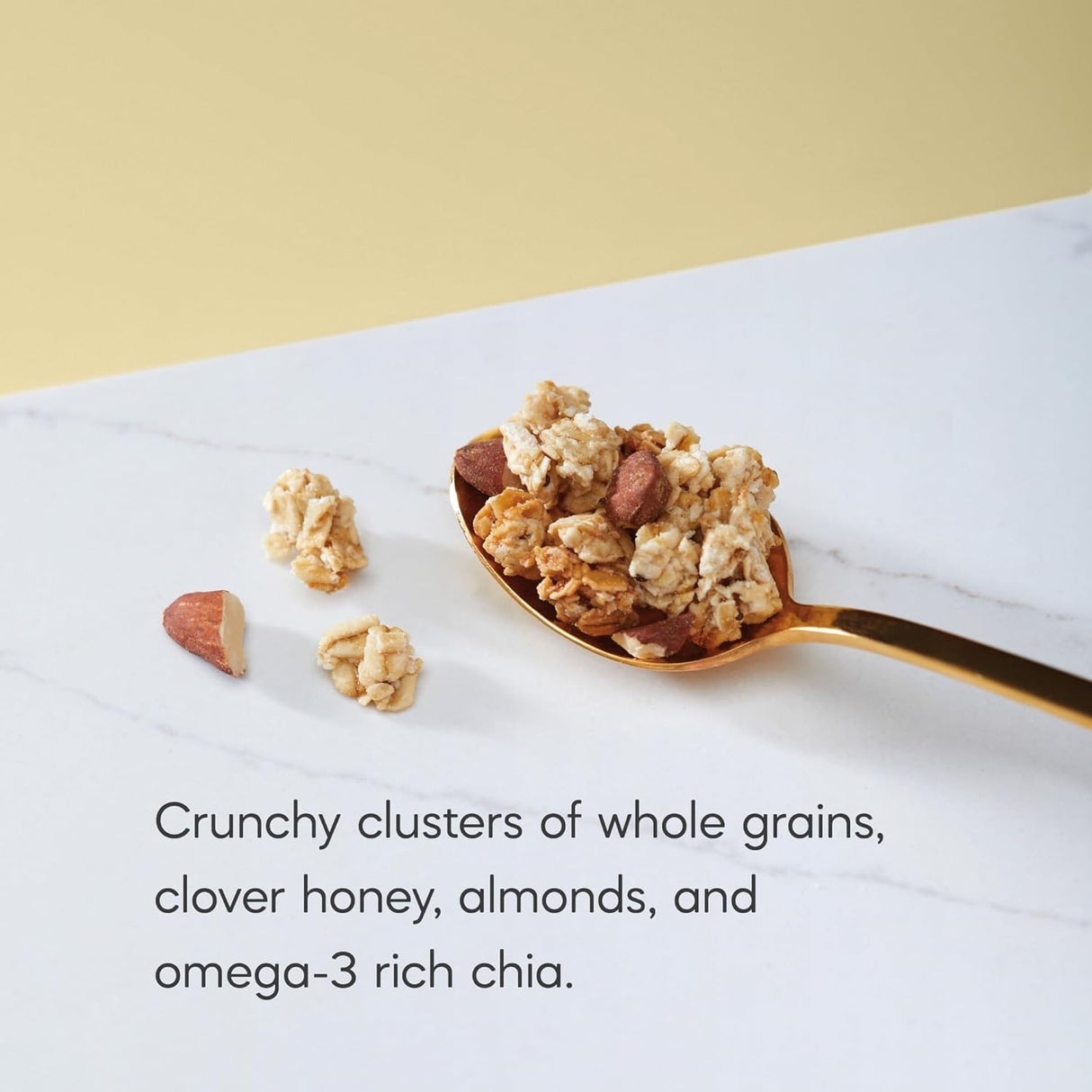 Spoonful of granola with text describing ingredients on a marble surface.