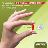 Hand holding a red vegan softgel with product details on a green background, featuring the Deva brand.