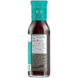 Bottle of sauce with a blue cap and label on a white background