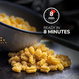 Cooked pasta on a dark surface with a colander and text indicating 'Ready in 8 Minutes'.