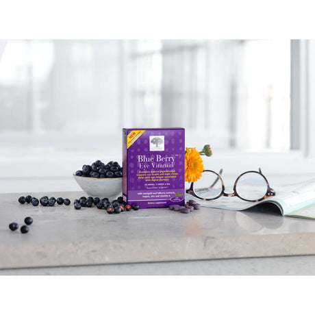 Box of Blue Berry Eye Vitamin on a table with blueberries and glasses in the background