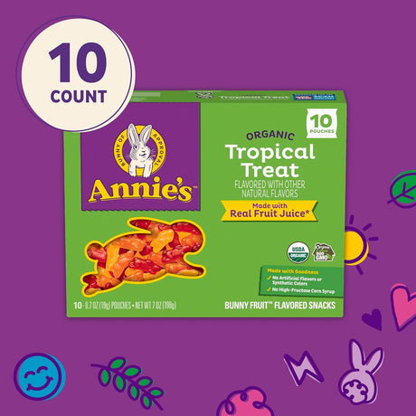 Box of Annie's Organic Tropical Treat snacks on a purple background with decorative elements.