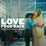 Person hugging a giant sandwich in an airport with text 'Love Food Back' and 'Nothing Works Faster'.