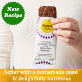 Hand holding a Simple Mills almond flour bar with text about a new recipe and product.