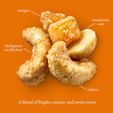 Cashews with labels for mangoes, macadamia nuts, and Madagascar vanilla bean on an orange background.