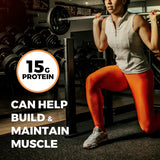 Person lifting weights with a focus on protein benefits in a gym setting
