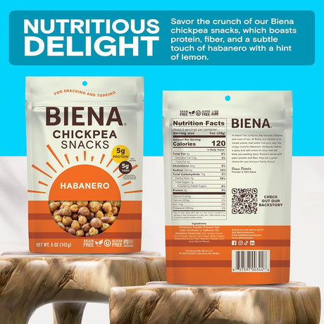 BIENA Habanero chickpea snack package with front and back views on a wooden surface against a blue background.