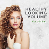 Woman with healthy-looking volume hair on a light background with text 'Healthy Looking Volume for thin hair'.