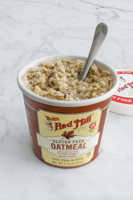 Bob's Red Mill gluten-free oatmeal cup with a spoon on a marble surface