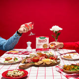 People enjoying a snack platter with Mary's Gone Crackers on a red background