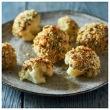 Baked cauliflower with breadcrumb topping on a rustic plate