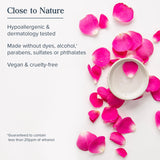 Candle with pink petals on a white background, featuring text about product attributes.