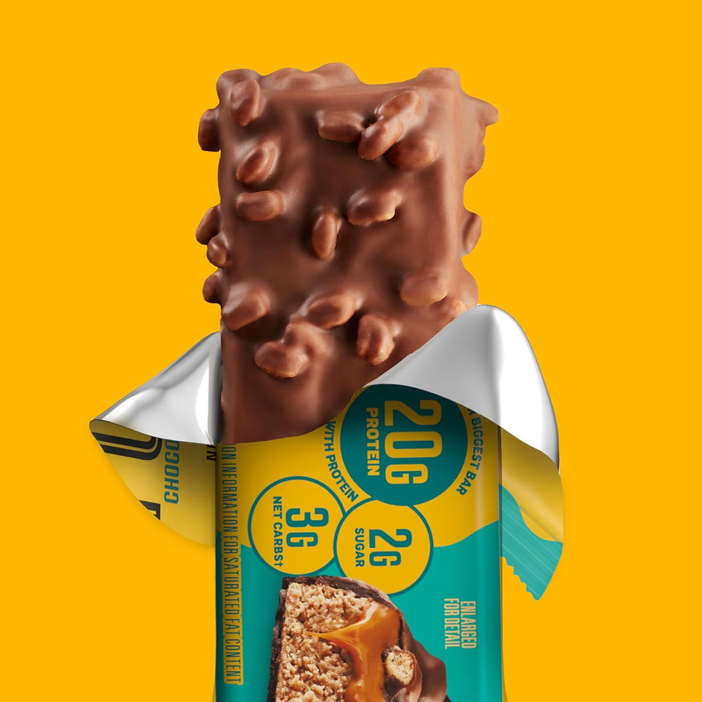 Chocolate-covered snack bar with a partially peeled wrapper on a yellow background