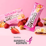 Fit Crunch bars with strawberries and pastries on a pink background, benefiting Susan G. Komen.
