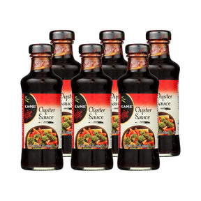 Six bottles of Kame Oyster Sauce on a white background