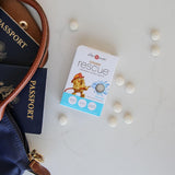 Ginger Rescue packaging with travel accessories on a light surface