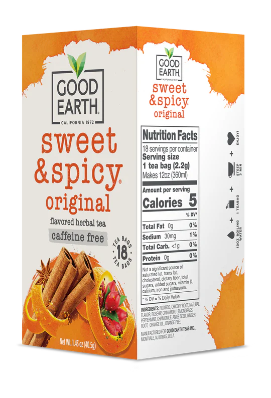 Good Earth Sweet & Spicy tea box with cinnamon sticks and red peppers on a white background