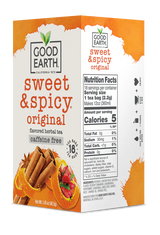 Good Earth Sweet & Spicy tea box with cinnamon sticks and red peppers on a white background