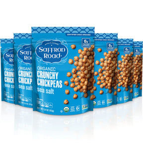 Multiple packages of Saffron Road Organic Crunchy Chickpeas sea salt on a white background