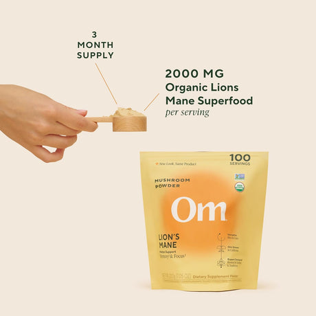 Om Lion's Mane mushroom powder package with a hand holding a scoop, on a beige background.
