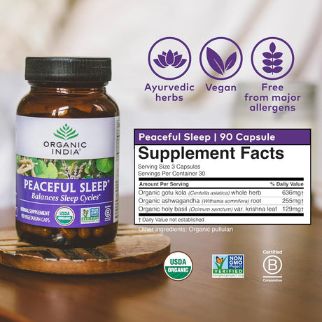 Supplement bottle labeled 'Peaceful Sleep' by Organic India on a wooden surface with product details.