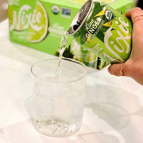 Person pouring Lime Ginger Nixie soda into a glass with a box of Nixie in the background.