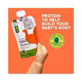 Serenity Kids Power Purees pouch held by a hand with promotional text on an orange background