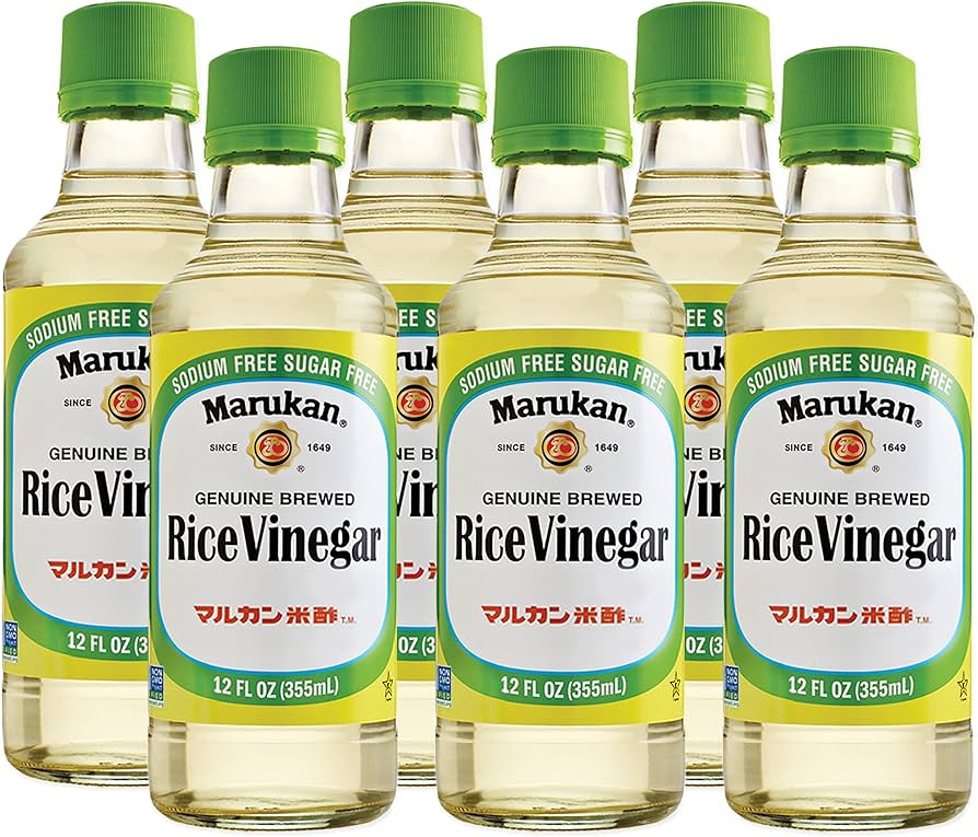 Six bottles of Marukan Rice Vinegar with green caps on a white background