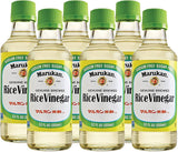 Six bottles of Marukan Rice Vinegar with green caps on a white background