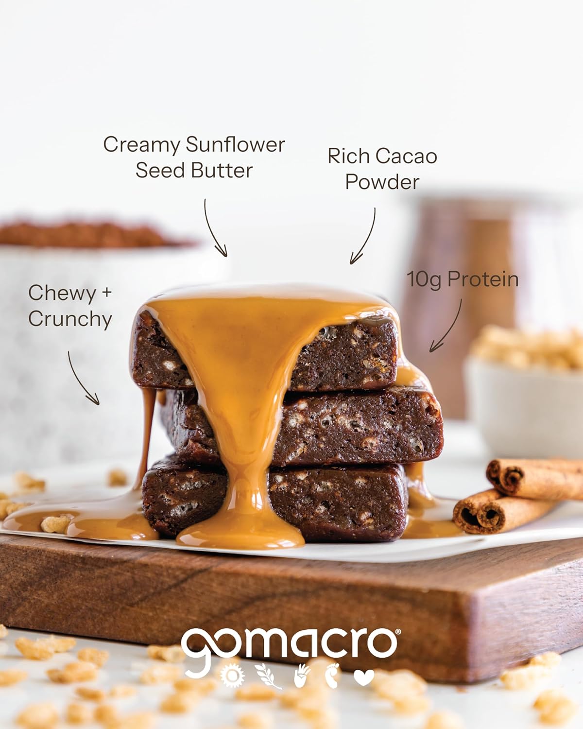 Stack of brownies with sunflower seed butter drizzle on a wooden board, featuring gomacro branding.