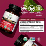Triphala supplement bottle with label on a magenta background