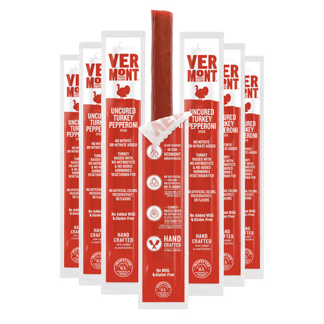 Vermont Uncured Turkey Pepperoni stick with multiple red and white packages on a white background