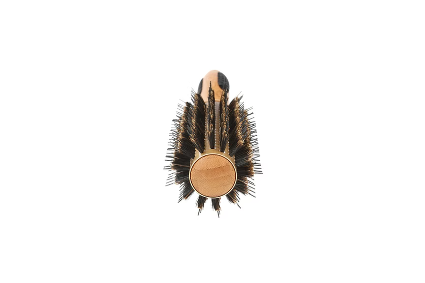 Hairbrush with bristle head and wooden handle on a white background