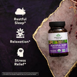 Supplement bottle labeled 'Peaceful Sleep' by Organic India on a textured surface with icons and text about sleep, relaxation, and stress relief.