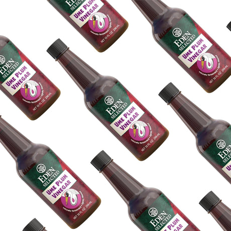 Multiple bottles of Eden Selected Ume Plum Vinegar arranged in a pattern on a white background.