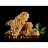Stack of breaded chicken tenders with a sprig of parsley on a black background