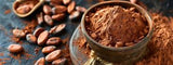 Cocoa powder in a wooden bowl with cocoa beans on a dark surface